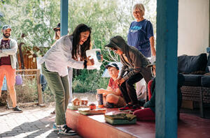 Cindy Hu demonstrating rainwater absorption to kids